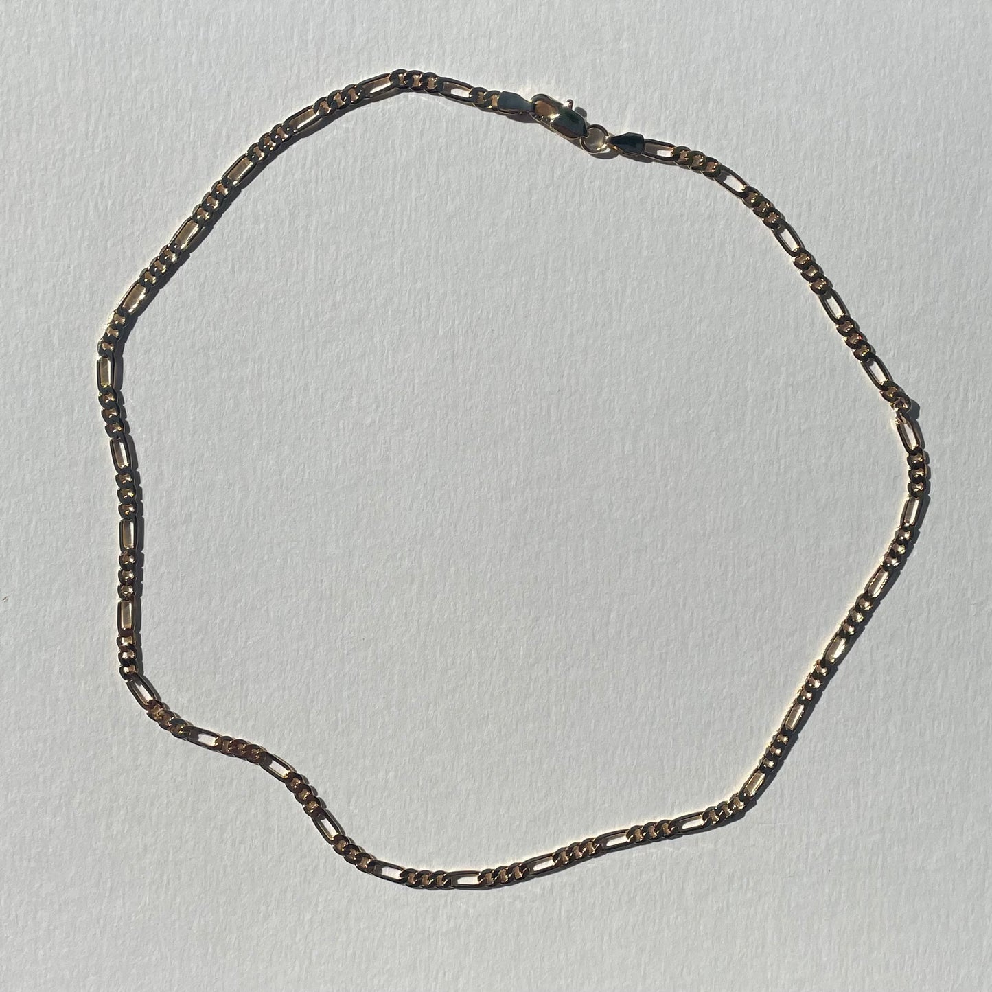 gold figaro chain